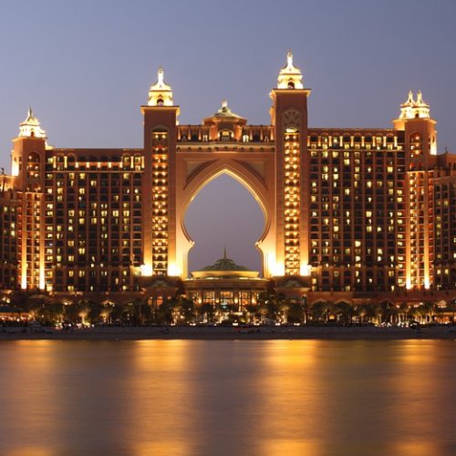 a large building with lights on with Atlantis, The Palm in the background