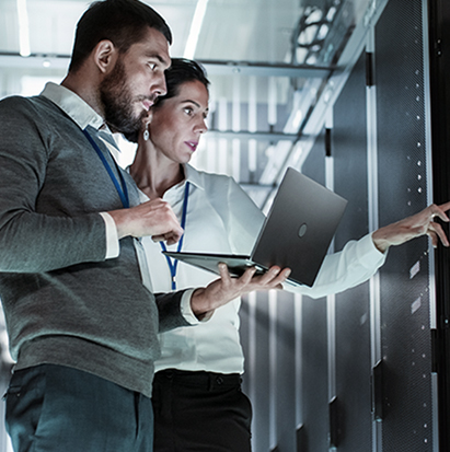 a man and woman standing in a server room