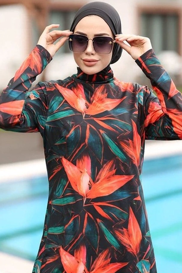 a woman wearing sunglasses and a floral print dress