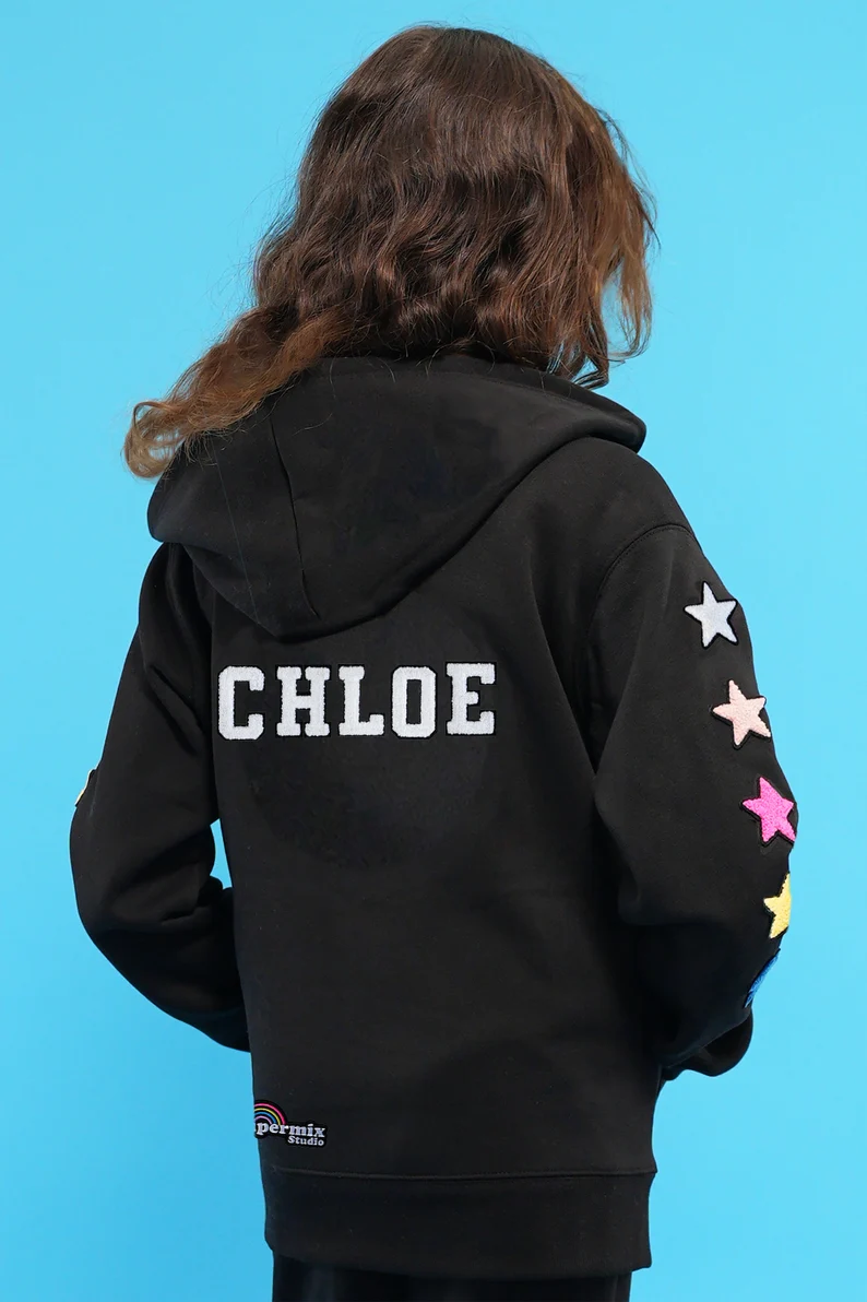 a person wearing a black hoodie with white text on it
