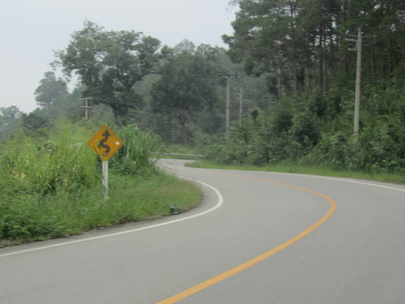 a road with a sign on the side