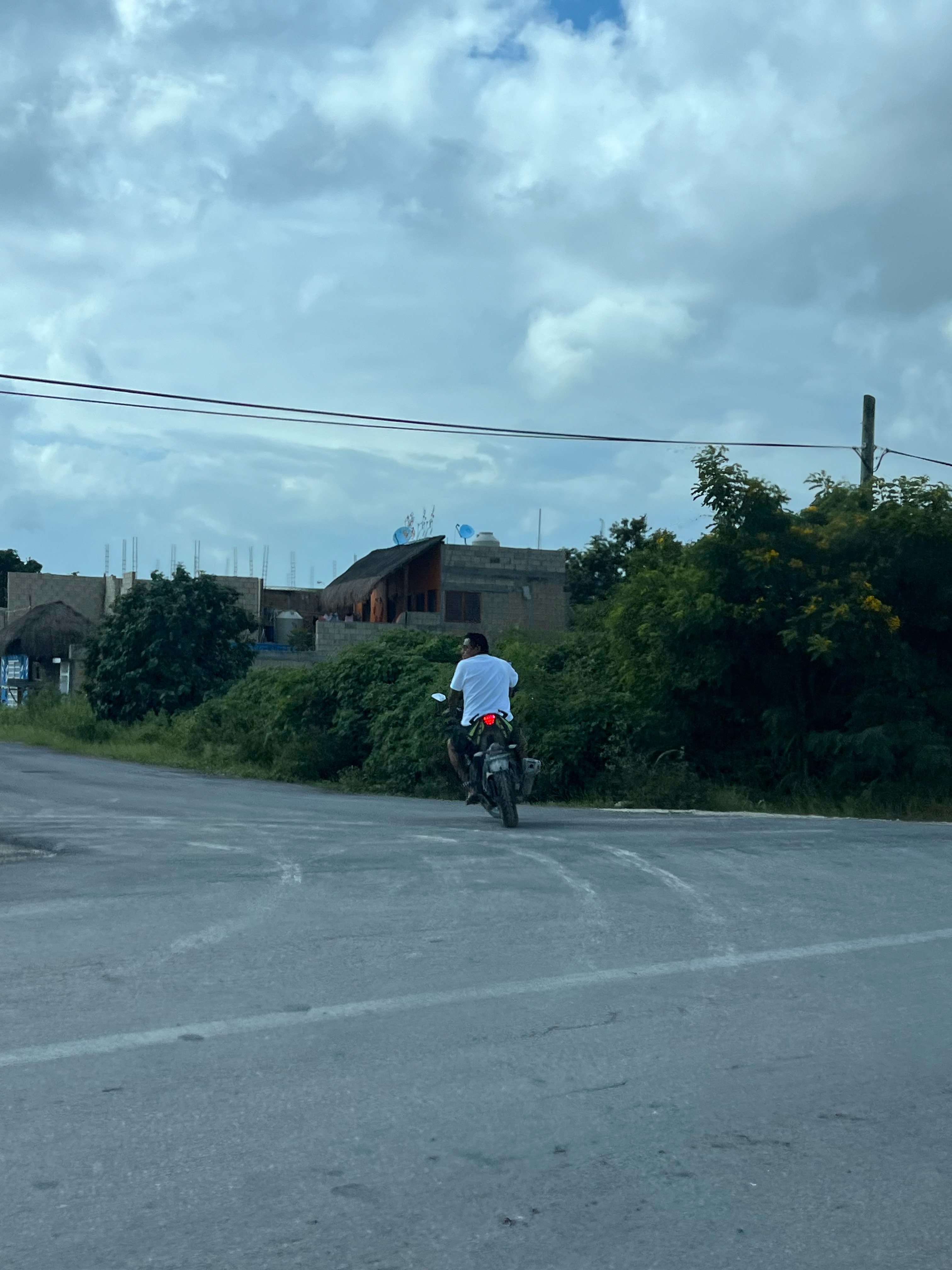 a man riding a motorcycle on a road