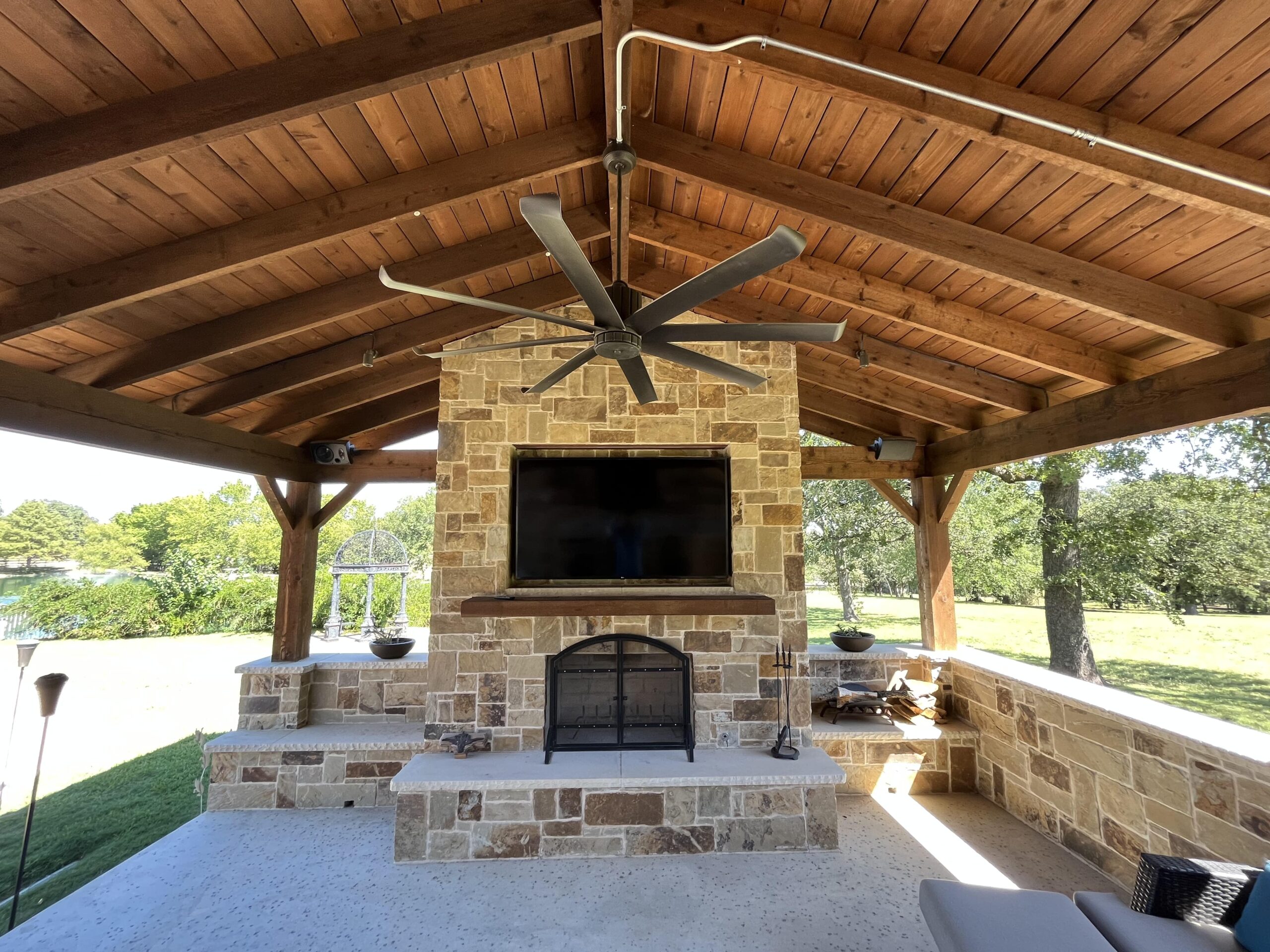 a outdoor fireplace with a ceiling fan
