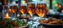 a group of glasses of beer and food on a table