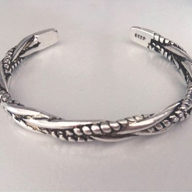 a silver bracelet with braided design