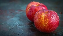 a group of apples on a black surface