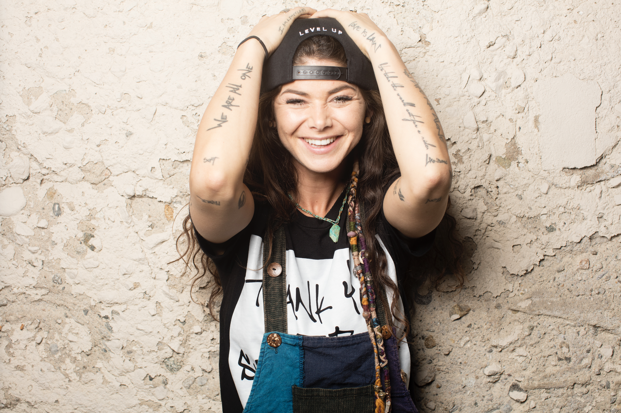 a woman smiling with her hands on her head