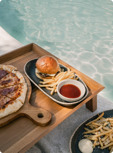 a tray of food next to a pool