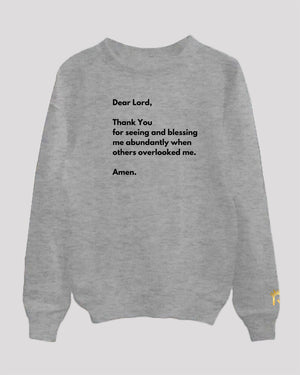 a grey sweater with black text
