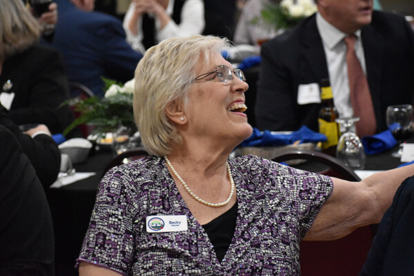 a woman laughing at a table