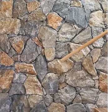 a stone wall with a wooden stick