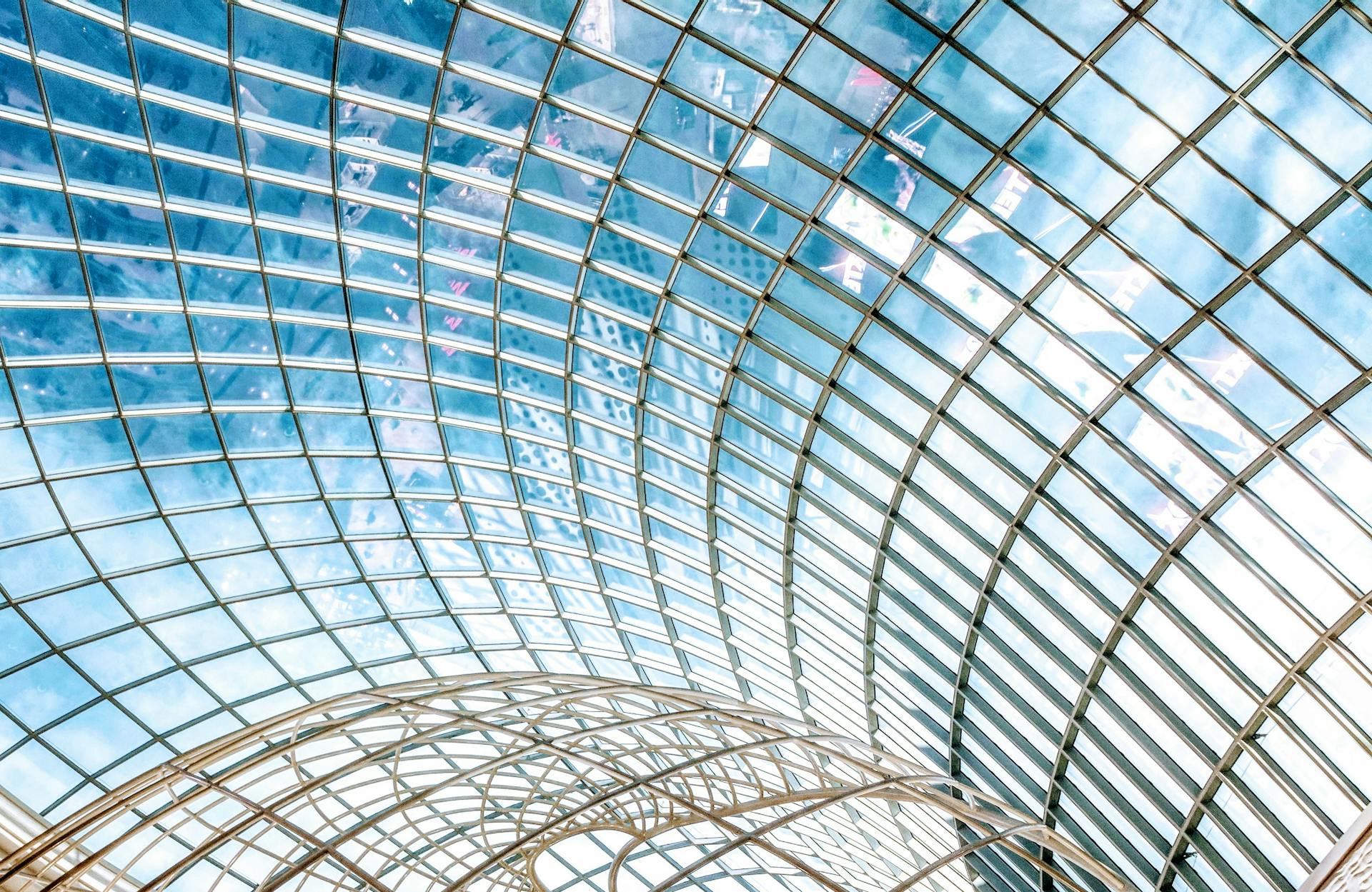 a glass roof with a metal structure