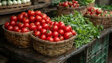 baskets of tomatoes and greens on a table