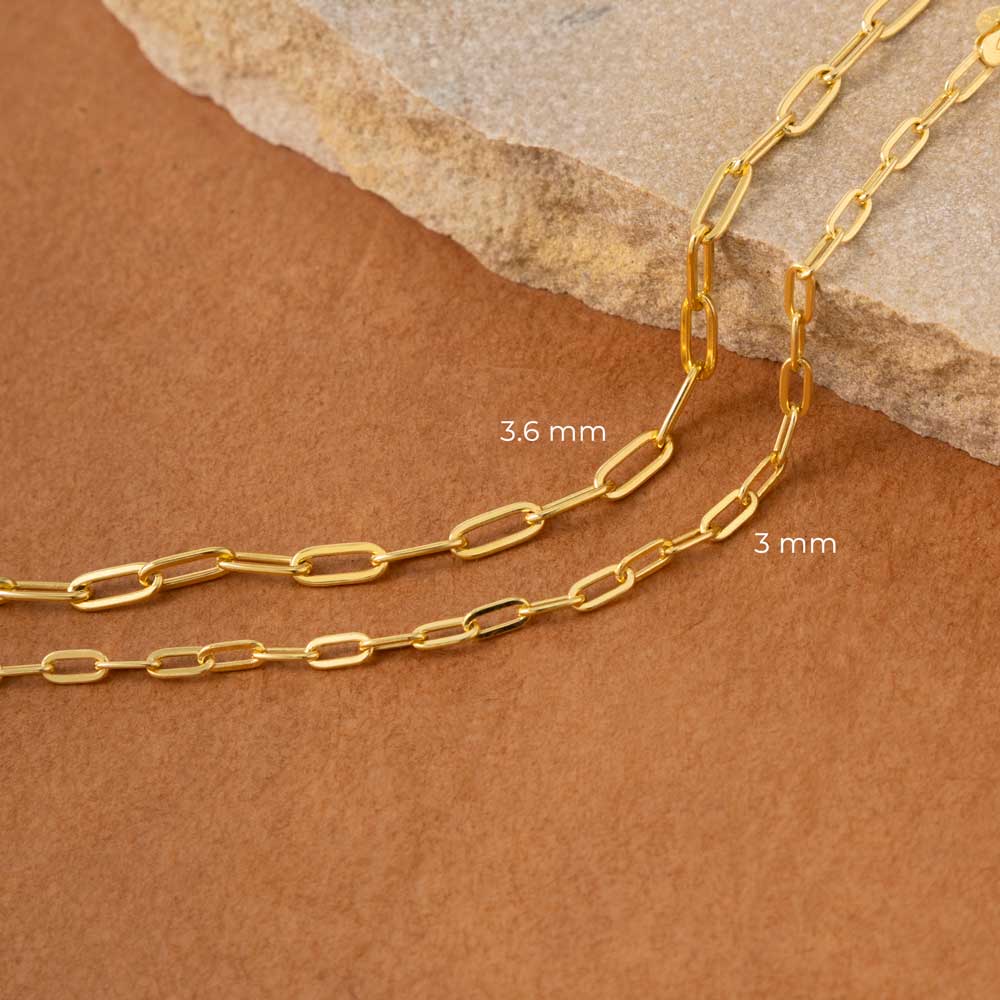 a gold chain on a rock