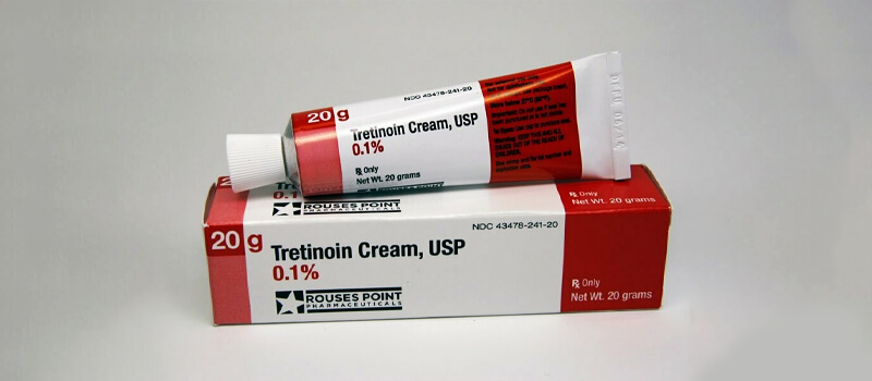a red and white tube of cream