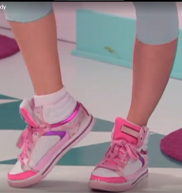 a pair of legs wearing pink and white shoes