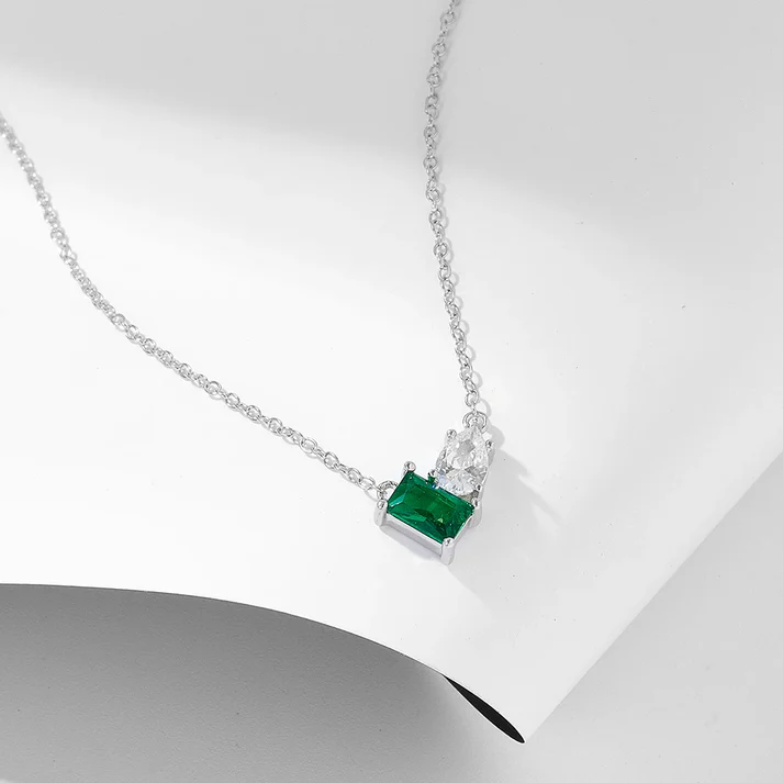 a necklace on a white surface