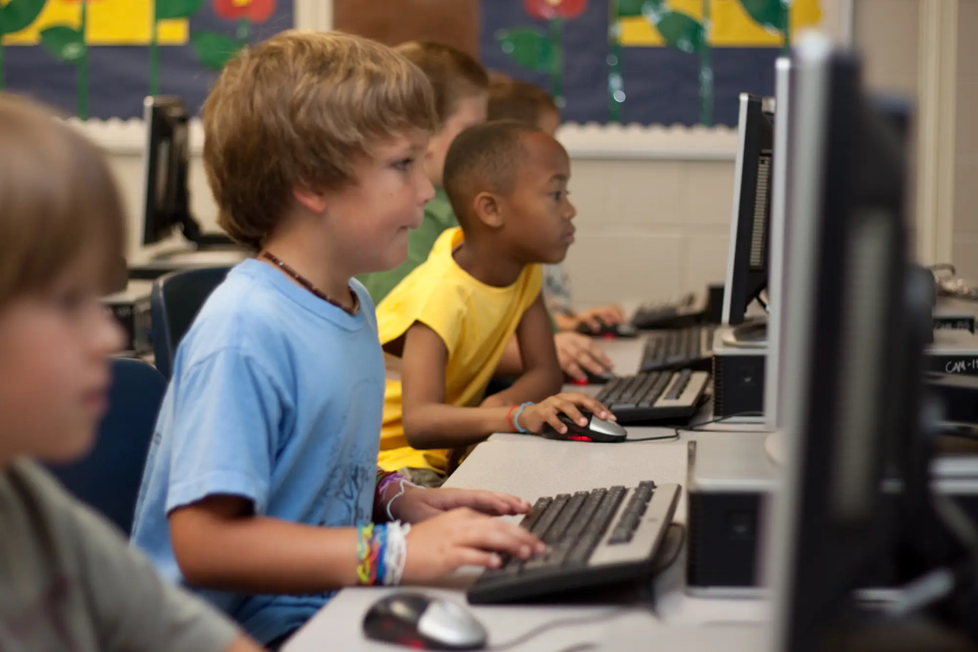 a group of kids using computers