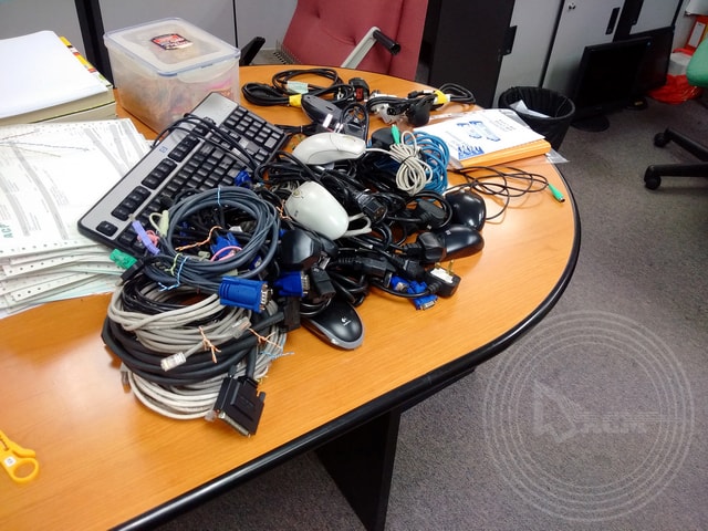 a group of computer cables and cords on a table