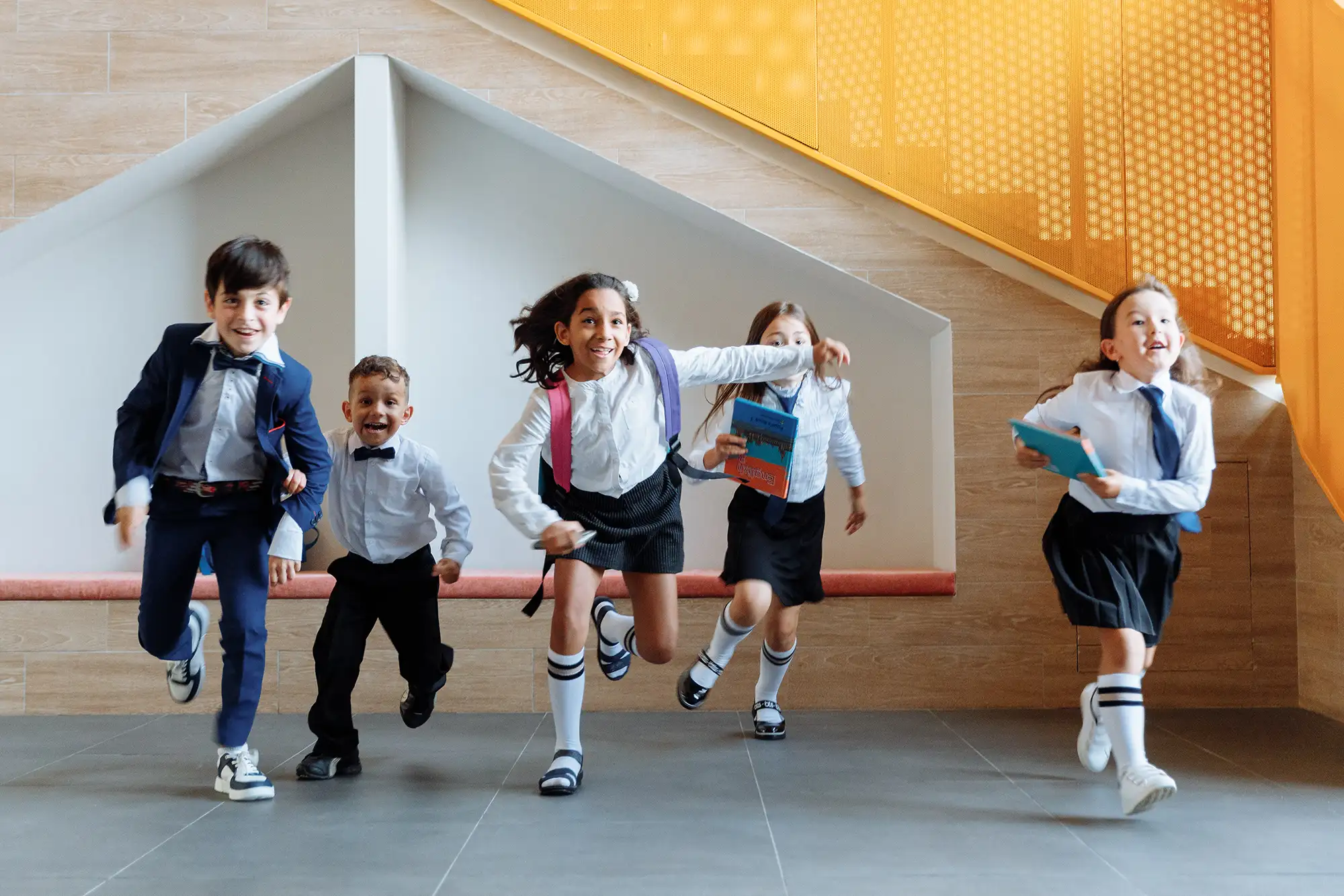 a group of children running in a hallway