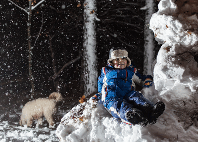 a child sitting on a pile of snow