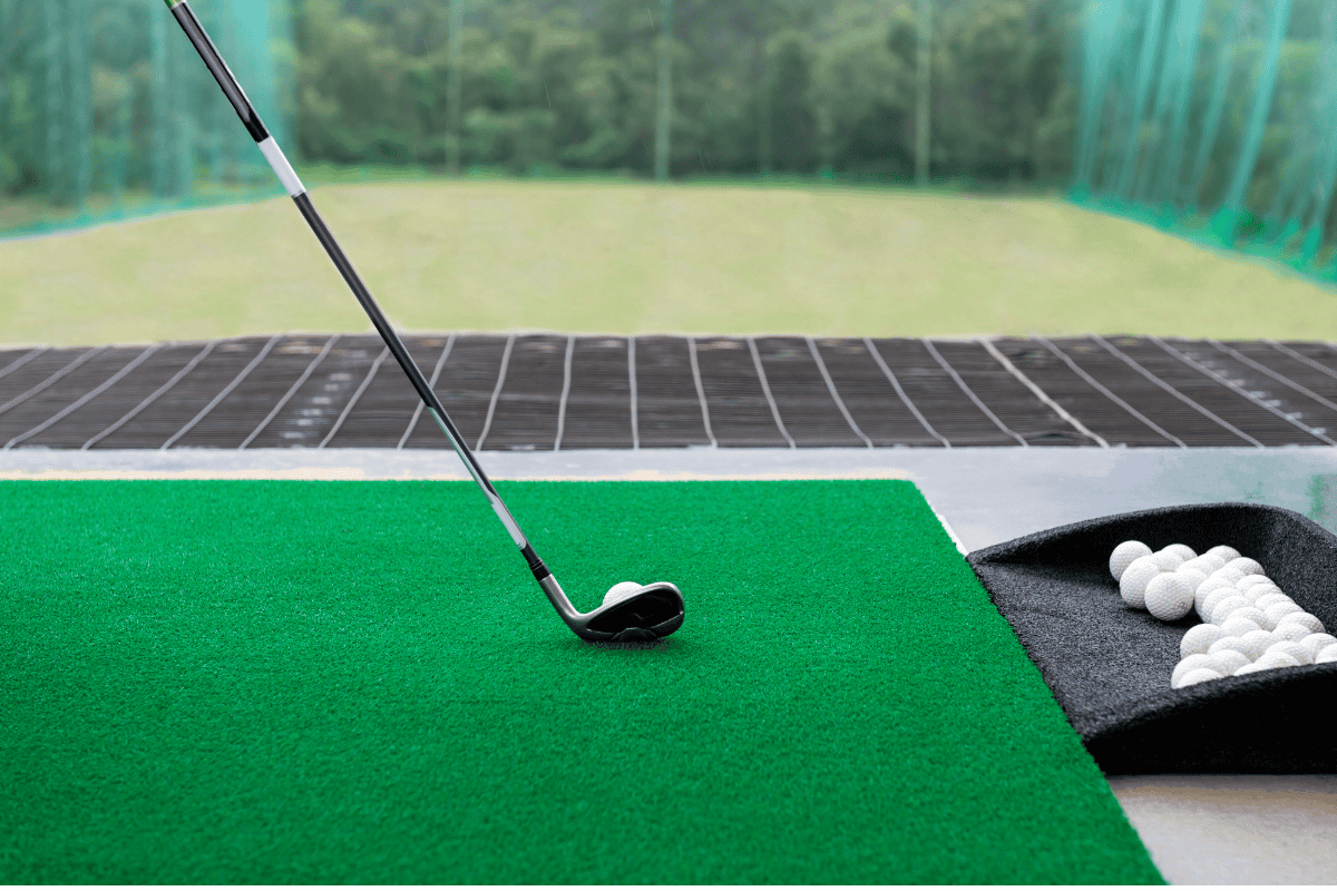 a golf club on a green surface