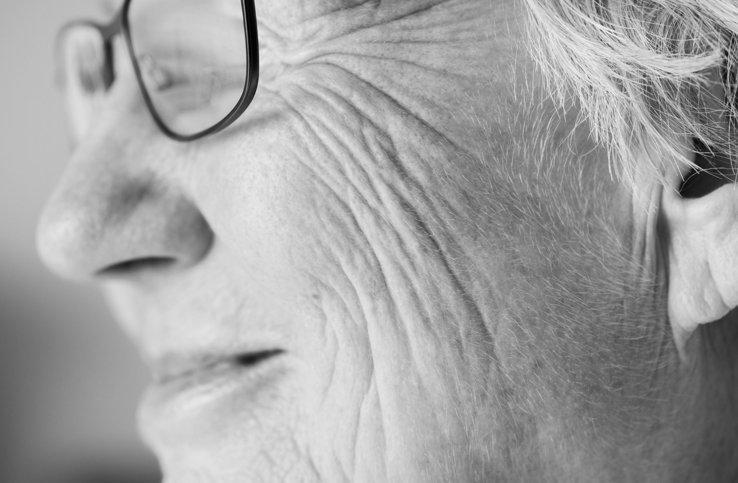 close up of an old woman's face with glasses