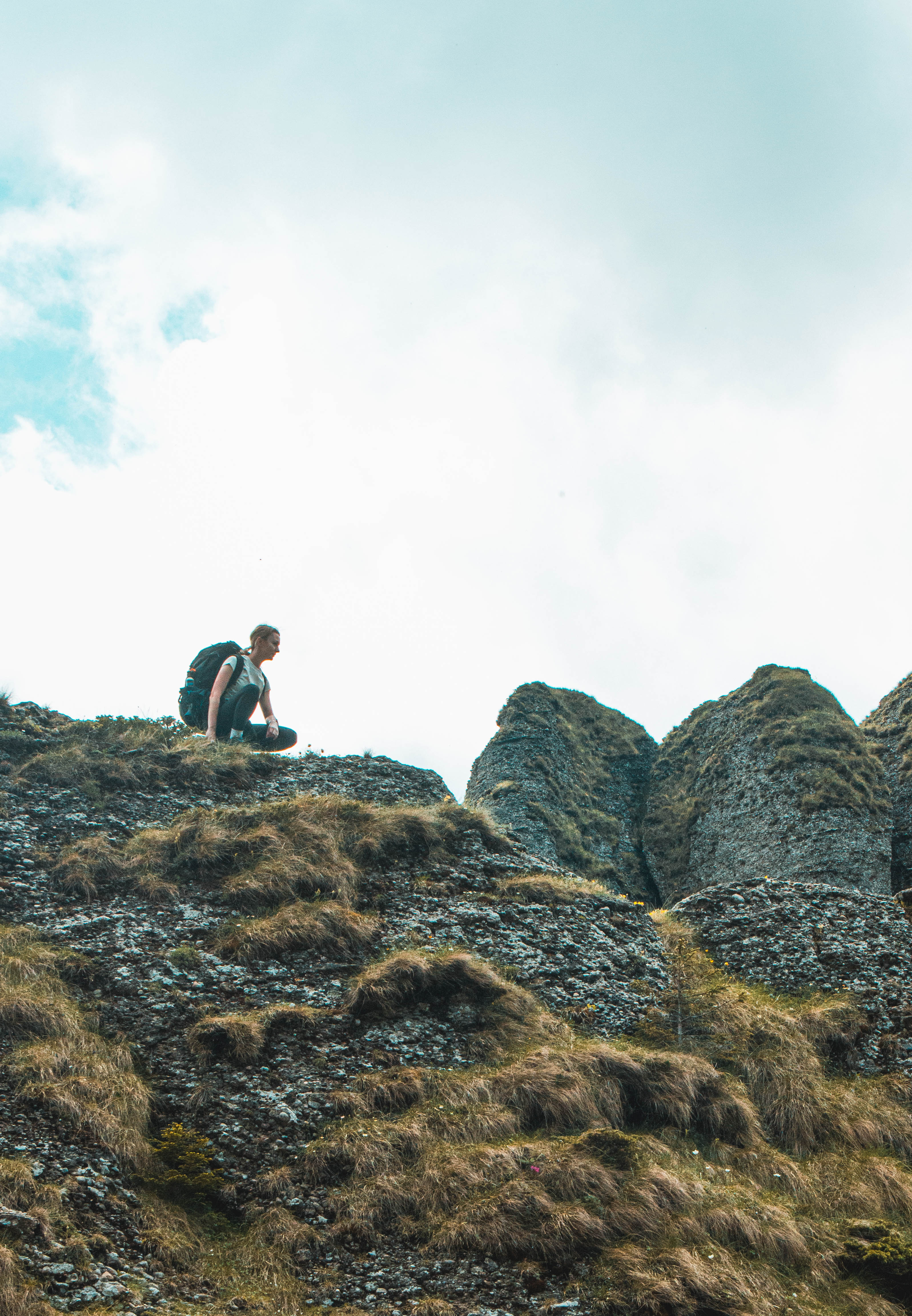 a man sitting on a rocky hill