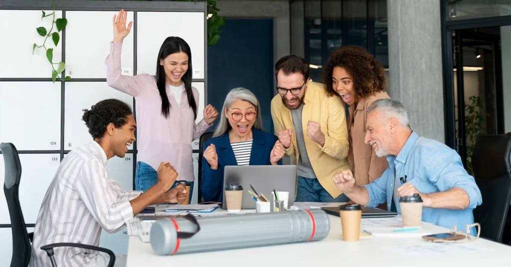 a group of people celebrating in an office