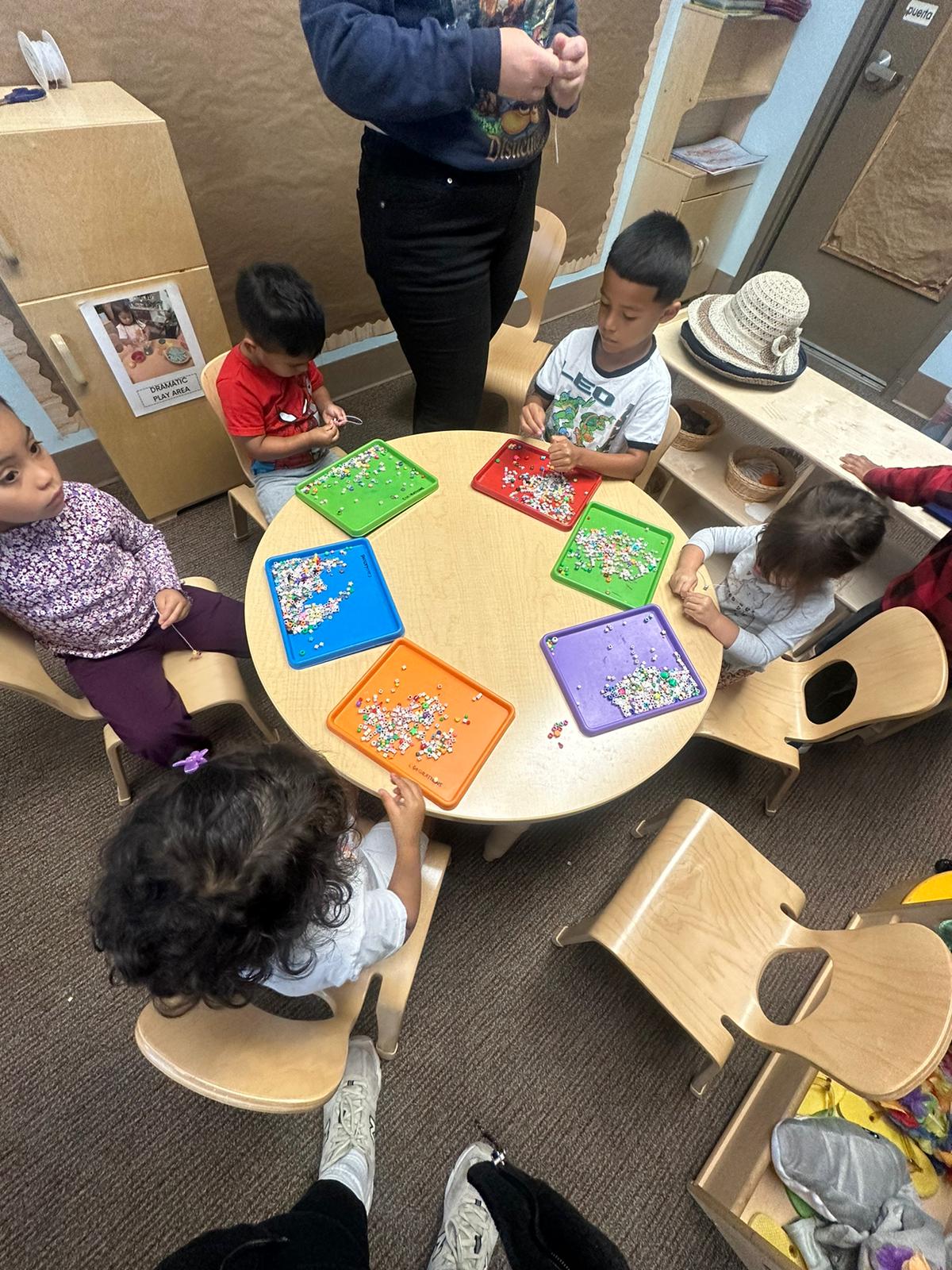 a group of children sitting around a table