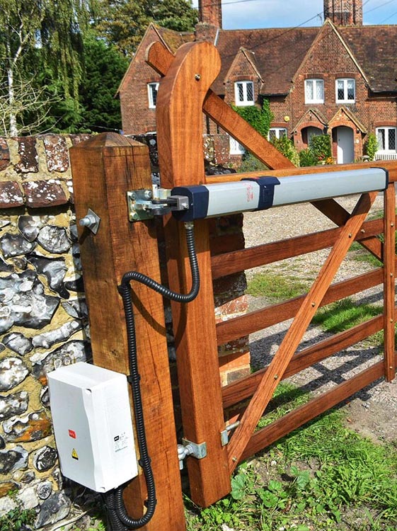 a wooden gate with a metal pole and a box
