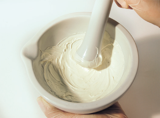 a person holding a mortar and pestle